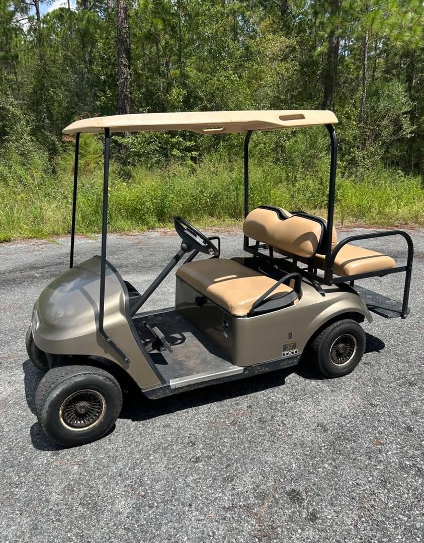 Bronze EZGO golf cart after repair
